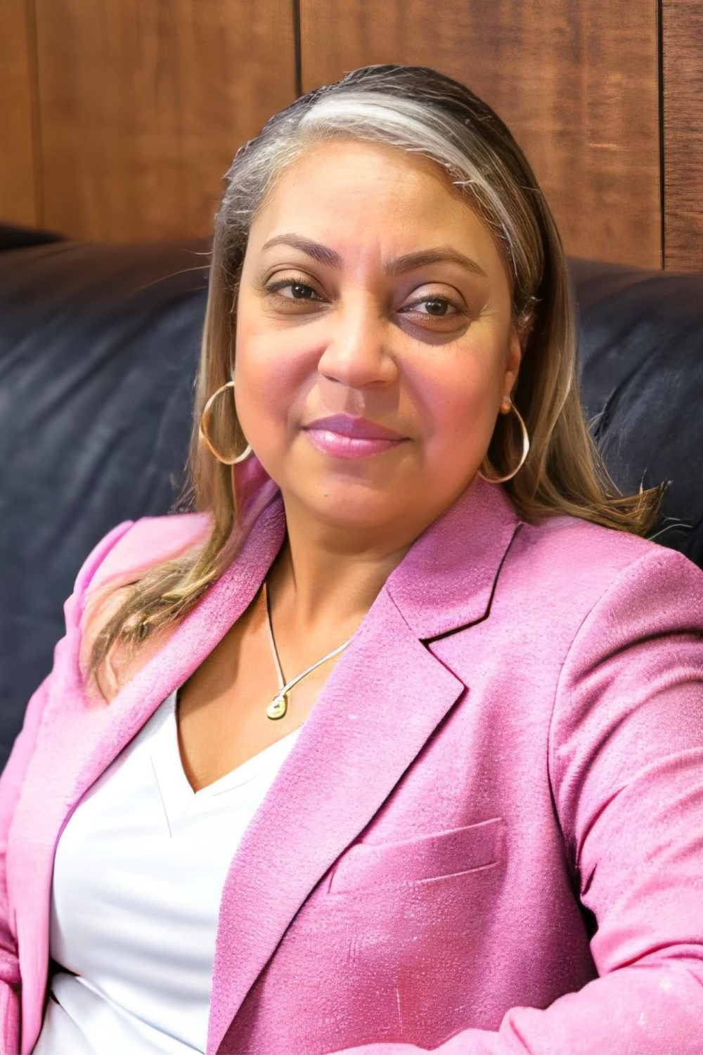 Patricia Forestal-Ortiz, professional real estate agent at Sunset Realty in St. Paul, wearing a pink blazer.